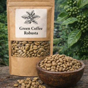 May include: A brown paper pouch with a clear window filled with raw green coffee beans, labelled Green Coffee Robusta with a botanical illustration. A wooden bowl filled with the same beans sits in front, with loose beans scattered nearby.