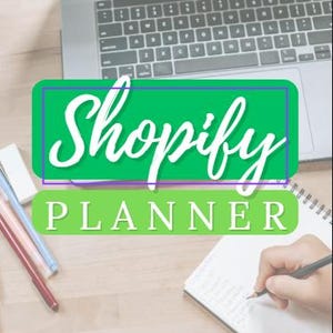 May include: A laptop, pens, and a notebook are on a wooden surface. The image features the text "Shopify Planner" in a green and white design. A person is writing in the notebook with a pencil. The scene suggests planning and organisation.