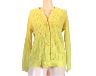 May include: A bright yellow cardigan sweater with a cable knit design. The sweater has a round neckline, long sleeves, and a button-up front. The garment is displayed on a mannequin.