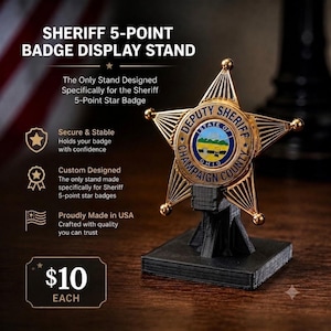 May include: A black 3D-printed display stand holding a gold-toned 5-point star Deputy Sheriff Champaign County Ohio badge. The text on the image reads: SHERIFF 5-POINT BADGE DISPLAY STAND, The Only Stand Designed Specifically for the Sheriff 5-Point Star Badge.