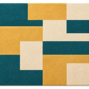 May include: A rectangular rug with a geometric pattern. The rug features blocks of teal, mustard yellow, and cream colors. The design is a modern, abstract arrangement of rectangular shapes, creating a visually appealing floor covering.