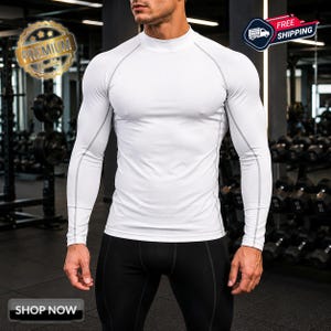 May include: A white long-sleeve compression shirt featuring a mock neck collar and visible grey seam detailing along the raglan sleeves and torso. The garment is form-fitting with a smooth, solid white fabric finish and long sleeves.