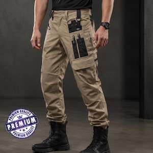 May include: Beige cargo pants featuring multiple black utility pockets, reinforced knee panels, and black tactical boots. The pants include integrated loops and various storage compartments on the thighs, paired with a black short-sleeved shirt.
