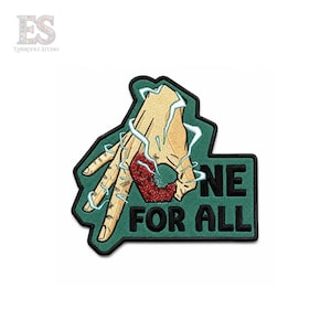 May include: An embroidered patch featuring a tan hand making an okay gesture with light blue lightning bolts surrounding it. A textured red circular shape is held by the fingers. The text ONE FOR ALL is stitched in black on a dark green background.
