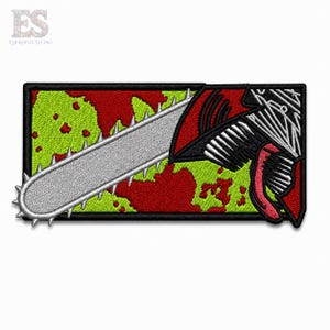 May include: A rectangular embroidered patch featuring a silver chainsaw blade extending across a background of red and lime green splatters. On the right side, a stylized character head with a black and white mechanical design is visible.