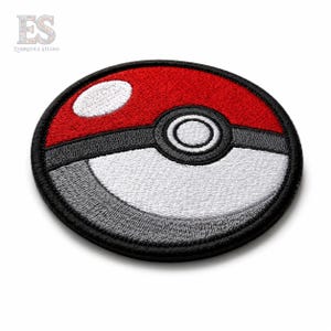 Red and white embroidered monster ball patch with black satin border on white background for jackets and backpacks