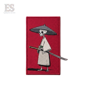 May include: Embroidered patch featuring a skeleton samurai with a katana and a traditional hat, set against a red background. The skeleton wears a white kimono with green accents. The patch has the text "ES" in the upper left corner.