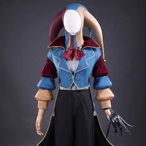 May include: A jester costume featuring a multi-coloured hood with three points and a small bell, a blue jacket with burgundy velvet sleeves, a red bow tie, and a light-coloured shirt. The outfit includes black trousers and a mechanical hand attachment.