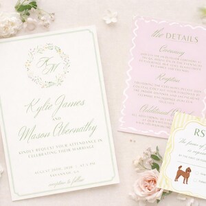 May include: A wedding invitation suite featuring a main card with green text and a floral wreath monogram, a pink details card with scalloped edges, and a yellow striped RSVP card with a brown dog illustration, surrounded by pale pink roses.