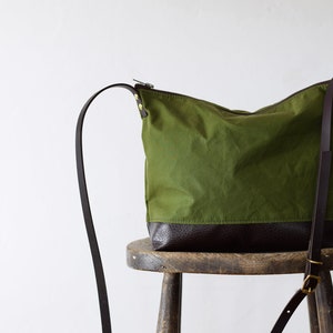 waxed canvas crossbody bag minimal design adjustable leather strap leather base image 3