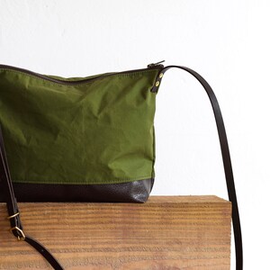 waxed canvas crossbody bag minimal design adjustable leather strap leather base image 6