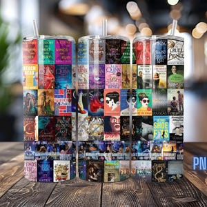 May include: Three stainless steel tumblers with book covers printed on them. The tumblers have a straw and are decorated with book titles such as "A Court of Thorns and Roses" and "Cruel Prince". The tumblers are on a wooden surface.