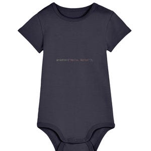 May include: A navy blue baby bodysuit with short sleeves. The text "println!("Hello, World!");" is printed in a light brown colour on the front. The bodysuit has snap closures at the bottom and a snap closure at the shoulder.