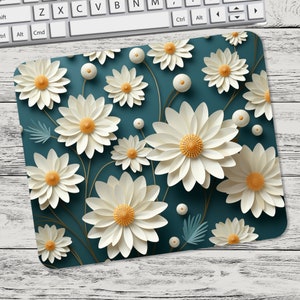May include: A teal blue mouse pad with a white daisy pattern. The daisies are layered and have a 3D effect.