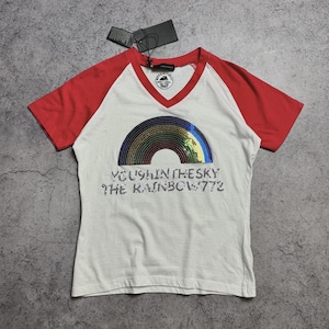 May include: White V-neck t-shirt with red sleeves. The shirt features a sequined rainbow design and the text "YOU9H IN THE SKY THE RAINBOW 772". A black tag hangs from the neckline.