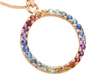 May include: A rose gold necklace with a circular pendant set with a rainbow of sapphires.