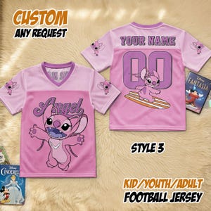 May include: Pink football jersey featuring the character Angel. The front displays the character's image and the word "Angel". The back has the number "00" and the text "YOUR NAME". The jersey is available in kid, youth, and adult sizes. The text "STYLE 3" is also visible.