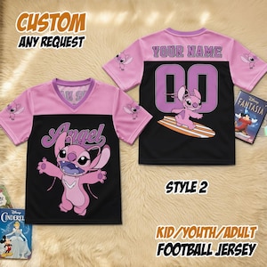 May include: A pink and black football jersey featuring a cartoon character and the word "Angel". The back has "YOUR NAME" and the number "00". The jersey is labelled "STYLE 2" and "KID/YOUTH/ADULT FOOTBALL JERSEY".