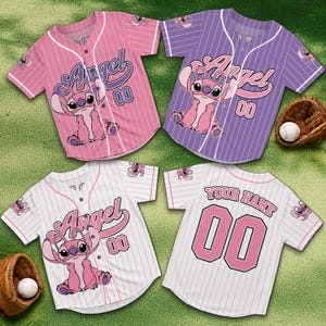 May include: Four baseball jerseys in pink, purple, and white with pinstripes. Each jersey features the character Angel, the number 00, and the word "Angel". Two baseball gloves and two baseballs are also visible.