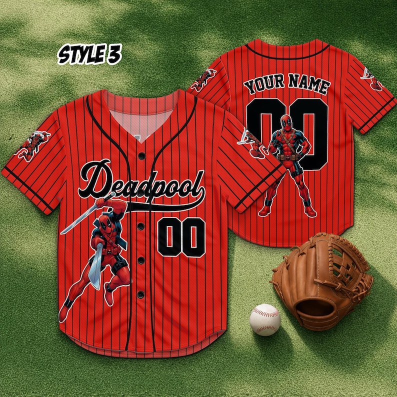 May include: Red baseball jersey with black pinstripes, featuring the word "Deadpool" in black script and the number "00". The jersey has a Deadpool graphic and the text "YOUR NAME" on the back. A baseball glove and ball are also visible.