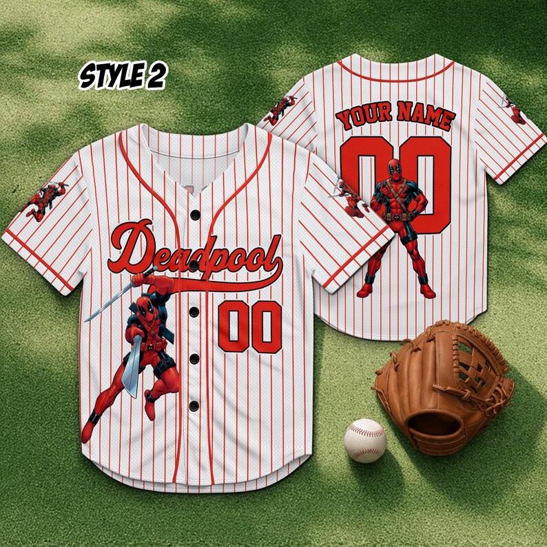 May include: White and red pinstripe baseball jersey with "Deadpool" and "00" in red. A Deadpool graphic is on the front. A baseball glove and ball are next to the jersey. The jersey is style 2.