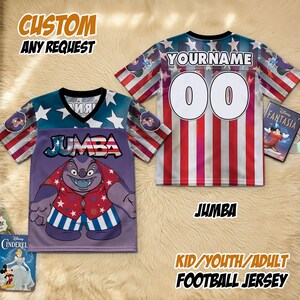 May include: Custom football jersey with a patriotic design. The jersey features a purple front with a cartoon character and the name "JUMBA". The back has red and white stripes, with the name "YOURNAME" and the number "00". The text "CUSTOM ANY REQUEST" is also visible.