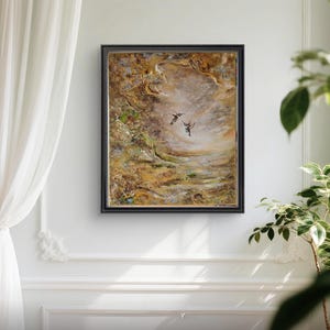 May include: A rectangular framed painting featuring two small birds in flight against a textured, abstract background of swirling golden, brown, and cream tones. The artwork is enclosed in a dark, thin frame, showcasing a layered, impasto-style application of paint that creates depth and movement across the canvas surface.