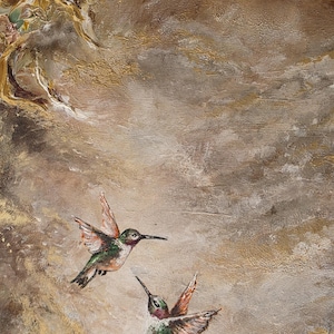 May include: An oil painting on canvas featuring two hummingbirds in flight against a textured background of swirling gold, bronze, and cream tones. The birds display iridescent green and red plumage, captured with thick, visible brushstrokes.