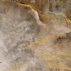May include: A textured abstract painting on canvas featuring a hummingbird in the lower left corner. The artwork displays a layered composition of metallic gold, deep brown, and muted gray tones with thick, visible brushstrokes and impasto paint.