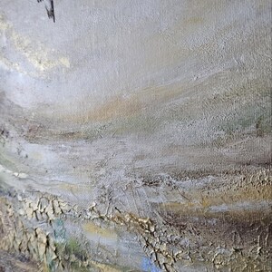 May include: A textured oil painting on canvas featuring two hummingbirds in flight against a neutral background. The artwork displays thick, layered brushstrokes in shades of beige, cream, and gold, with subtle hints of green and blue throughout.