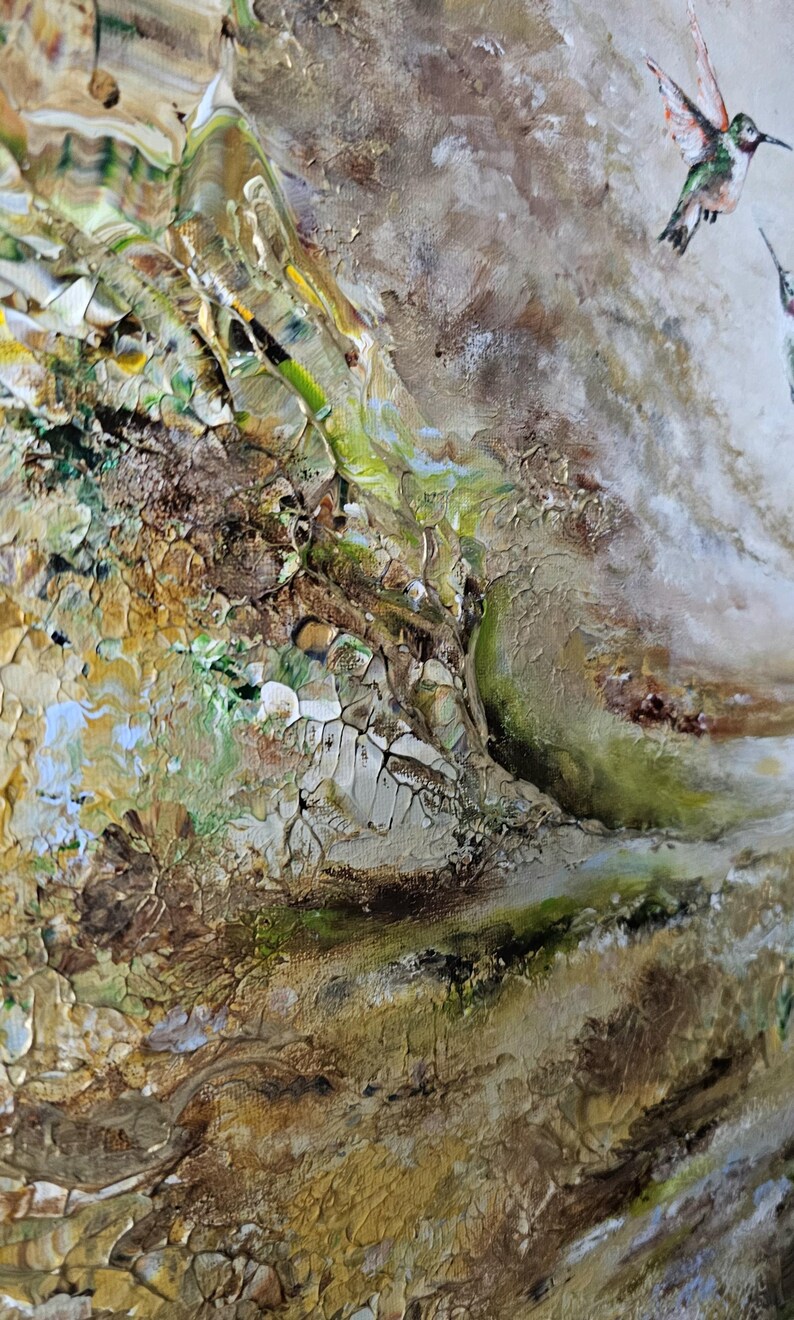 May include: An abstract acrylic painting featuring a textured landscape with earthy tones of brown, gold, and green. The composition includes a small, detailed hummingbird in flight, rendered with white, green, and orange accents against a neutral background.