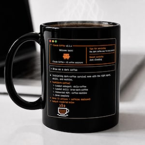 May include: Black coffee mug with a computer-themed design. The mug features text that reads "Claude Coffee v2.1.6" and "Brew me a dark coffee." The design includes a pixelated coffee cup icon and a list of commands. The mug is filled with hot coffee.