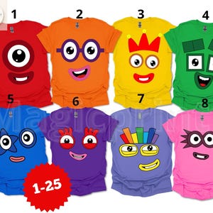 May include: A collection of eight colorful t-shirts featuring cartoon character designs. Each shirt is a different color, including red, orange, yellow, green, blue, purple, light purple, and pink. The designs include various faces with large eyes and smiles.