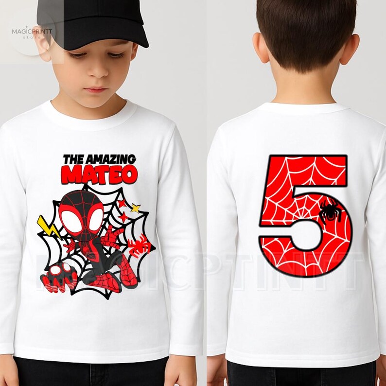 May include: White long-sleeve shirt featuring a cartoon Spider-Man design with the text "THE AMAZING MATEO" on the front. The back of the shirt displays a large red number 5 with a spiderweb design and a spider.