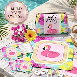 May include: A Mahj set featuring a zippered pouch, two mats, and tiles, all decorated with a pink flamingo float pattern, yellow hibiscus flowers, and plaid accents. The set includes a small instruction booklet and a set of game tiles.
