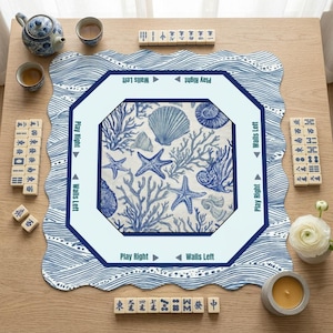 Square and octagonal scalloped mahjong mat for table in blue and white ocean wave print, both showing printed wall direction guides — a mah jongg mat with rules in two shapes. A beautiful mahjong table mat for American mahjong players of all levels.