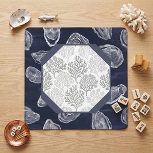 Elevate your game night with a nautical mahjong mat featuring hand-illustrated oyster shells and coral motifs. This stylish mahjong accessory blends perfectly with coastal home decor and upscale gaming setups for a sophisticated look.