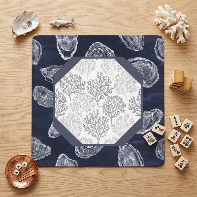 Elevate your game night with a nautical mahjong mat featuring hand-illustrated oyster shells and coral motifs. This stylish mahjong accessory blends perfectly with coastal home decor and upscale gaming setups for a sophisticated look.