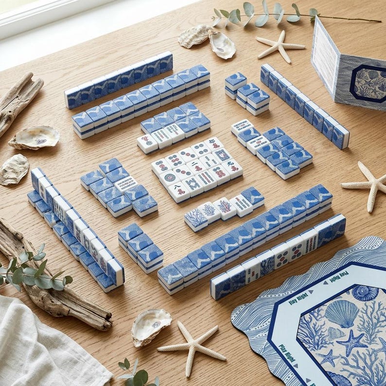 Close-up of American mahjong tiles with custom blue and white coral print backs, showing tile weight and finish quality — a premium mahjong tile set for players upgrading from a basic set, with a custom back design rarely found in standard mah jongg tiles.