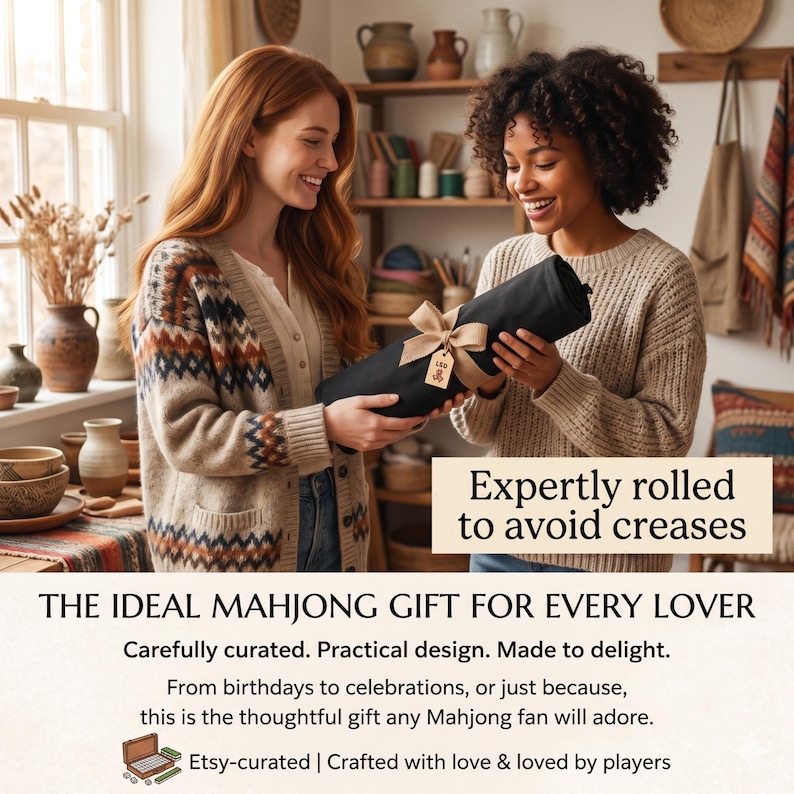 May include: Two people holding a rolled-up black item tied with a tan ribbon and a small tag. The text on the image says, "Expertly rolled to avoid creases" and "THE IDEAL MAHJONG GIFT FOR EVERY LOVER."