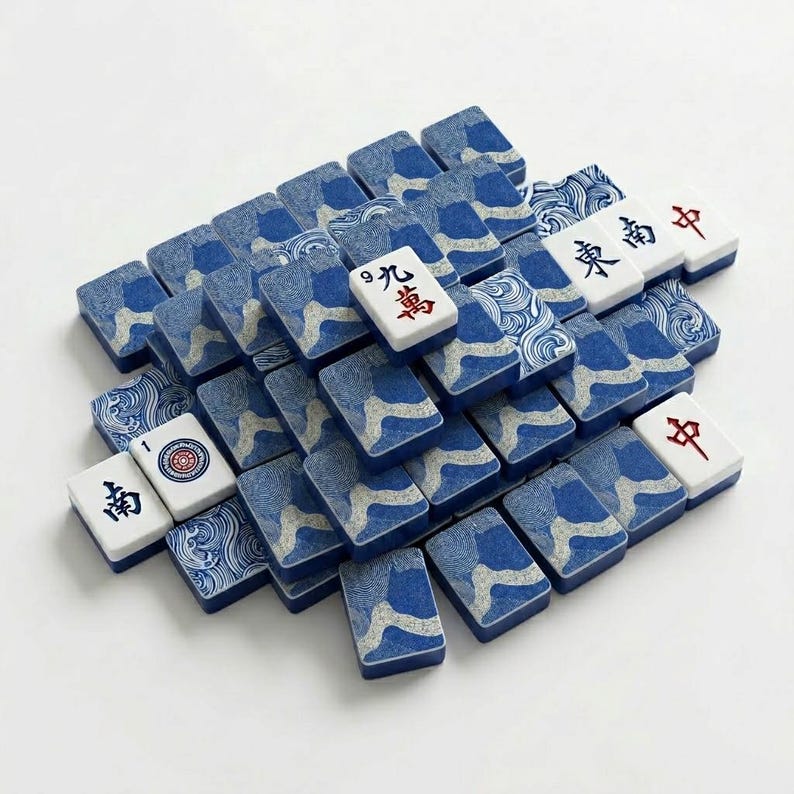 Close-up of American mahjong tiles with custom blue and white coral print backs, showing tile weight and finish quality — a premium mahjong tile set for players upgrading from a basic set, with a custom back design rarely found in standard mah jongg tiles.