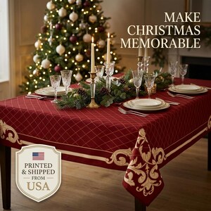 May include: A deep red tablecloth featuring a gold diamond grid pattern and ornate gold scrollwork borders. The table is set with white plates, clear crystal glasses, and two tall taper candles. Text reads: MAKE CHRISTMAS MEMORABLE.