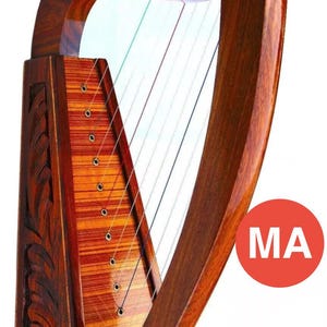 May include: A wooden harp with a dark brown finish. The instrument has a curved neck and a soundbox with detailed carvings. Strings are stretched across the frame. The harp is a musical instrument, often used in traditional music.