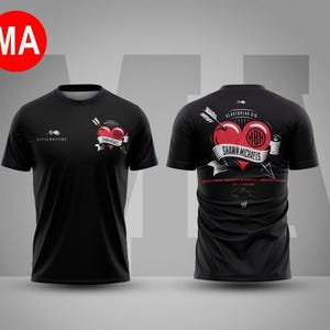 May include: Black t-shirt featuring a red heart pierced by an arrow, with the text "Shawn Michaels" on a banner. The shirt also has the text "Civil Regime" and the initials "HBR". The back of the shirt has the text "Heartbreak Kid".