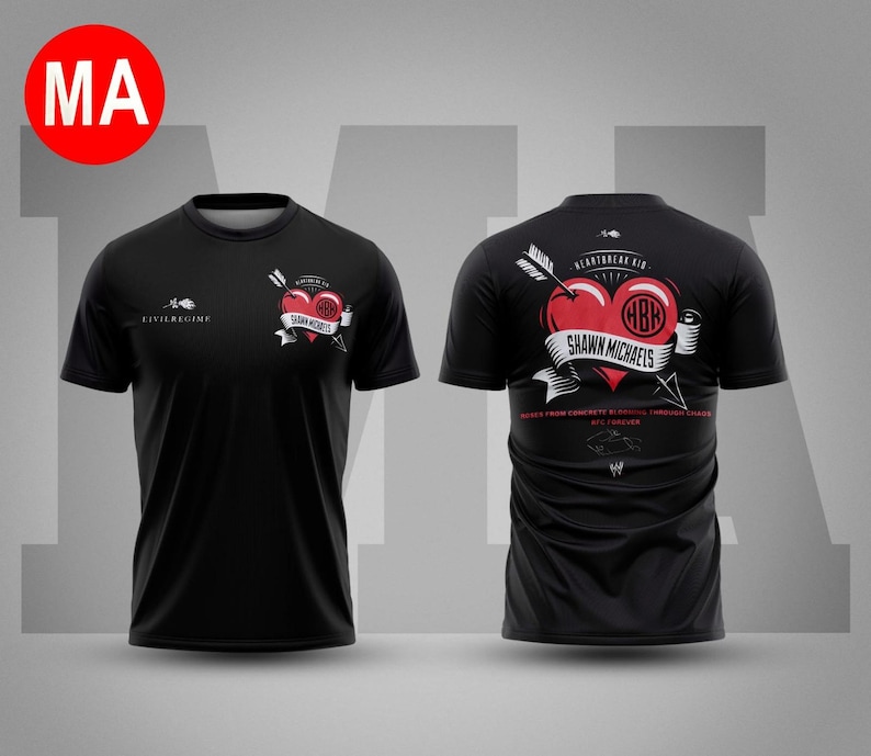 May include: Black t-shirt featuring a red heart pierced by an arrow, with the text "Shawn Michaels" on a banner. The shirt also has the text "Civil Regime" and the initials "HBR". The back of the shirt has the text "Heartbreak Kid".