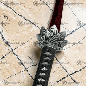 May include: A sword with a deep red blade featuring a wavy pattern, a silver metal handguard shaped like a blooming lotus flower, and a black cord-wrapped handle with a textured underlay, all displayed against a light marble background.
