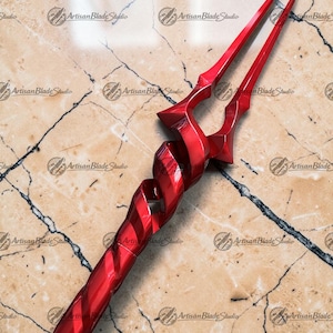 May include: A red spear with a twisted handle and a forked blade. The spear is made of a shiny, metallic material and has a detailed design. The background is a marble surface.
