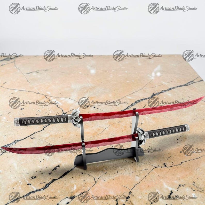May include: Two katana swords with translucent red blades and black wrapped handles featuring silver-toned metal accents. The swords are displayed horizontally on a black tiered stand, with the blades showing a subtle wavy pattern.