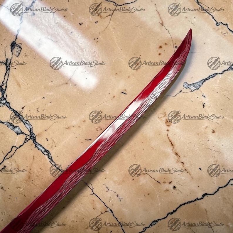 May include: A curved sword blade featuring a deep red finish and a visible wavy pattern along the edge. The blade displays a sharp, pointed tip and a metallic texture that contrasts with the vibrant red color across the surface of the steel.