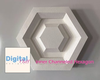 May include: White, three-dimensional, hexagonal shaped wall decor with a channeled design. The text "Inner Channeled Hexagon" is printed on the bottom of the decor.